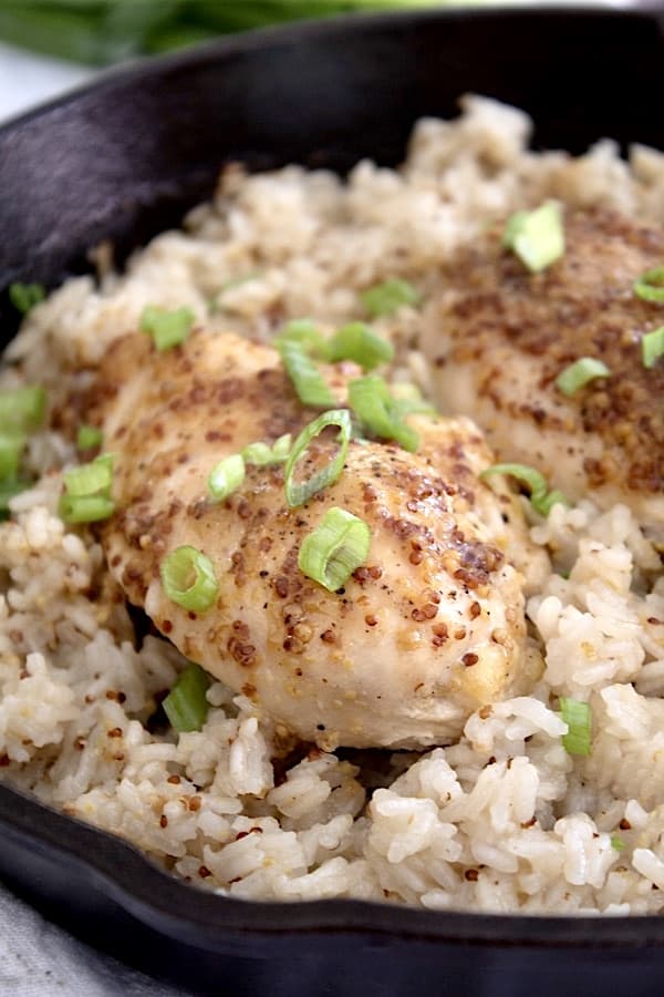 honey mustard coated chicken with fluffy rice in black pan