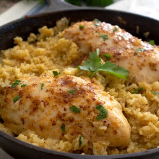 front view of honey mustard chicken and rice in cast iron pan
