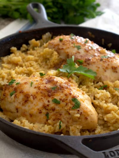 front view of honey mustard chicken and rice in cast iron pan