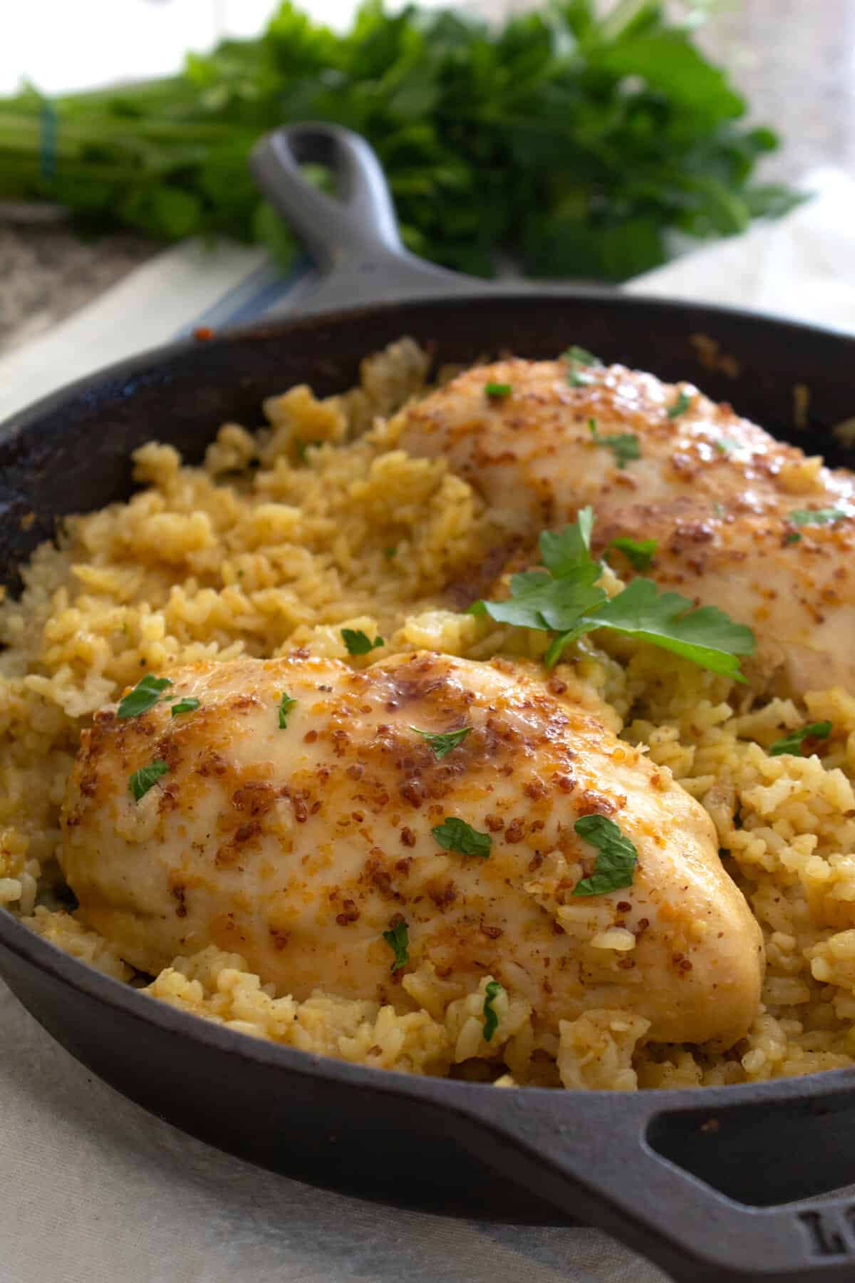 honey mustard chicken and rice in a cast iron pan
