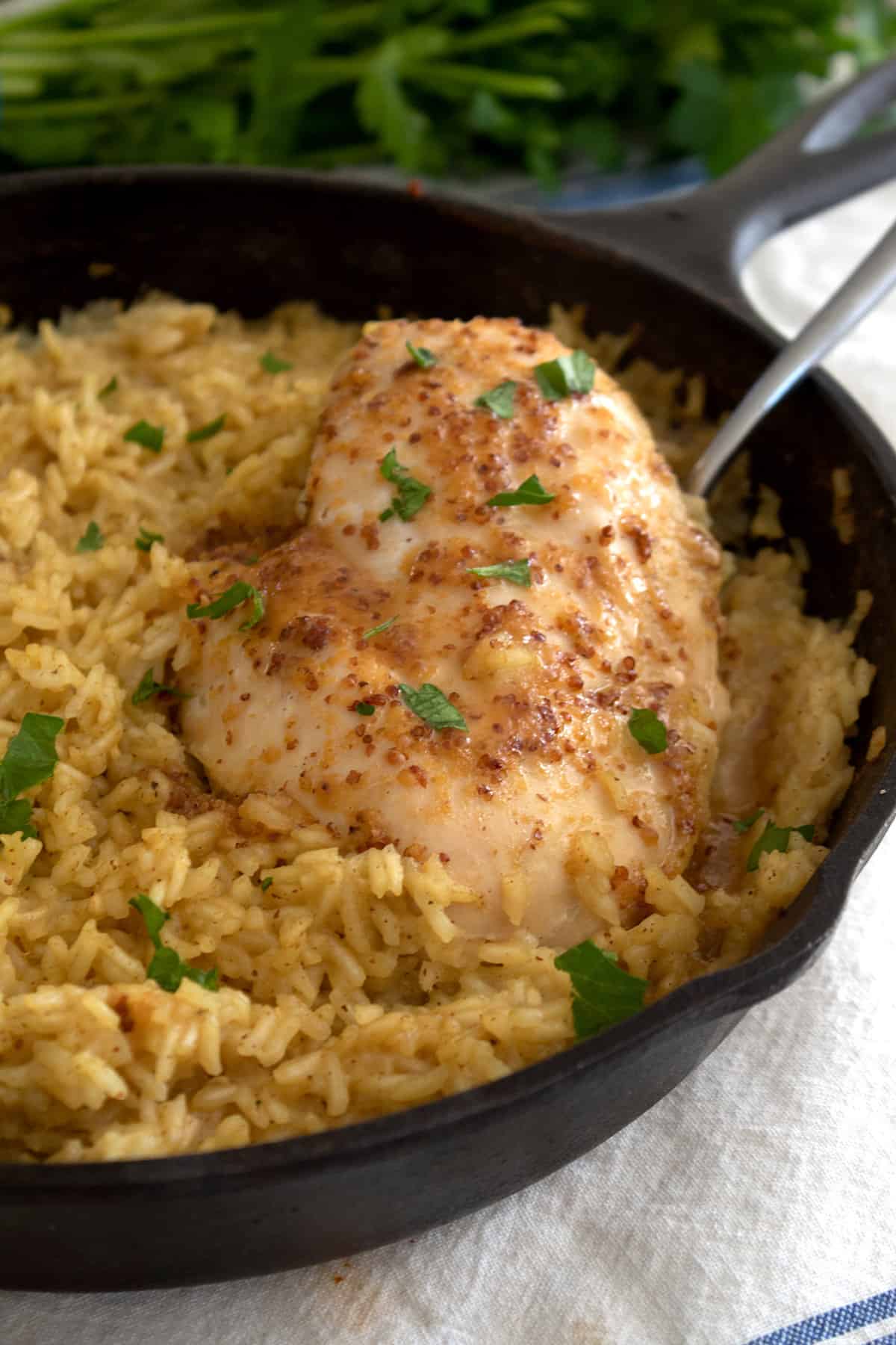 chicken breast with rice and honey mustard in cast iron pan after baking