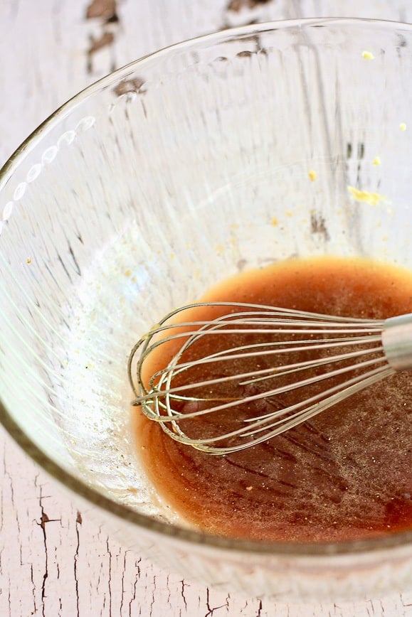 A glass bowl filled with a marination mixture