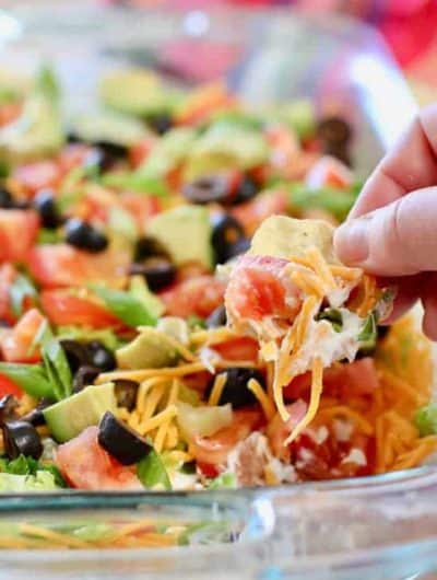 Skinny Taco Dip being scooped up with a tortilla chip