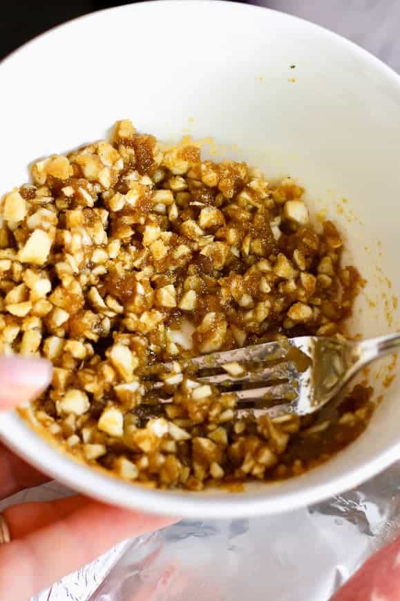 mixture in a white bowl of brown sugar garlic olive oil and salt pepper