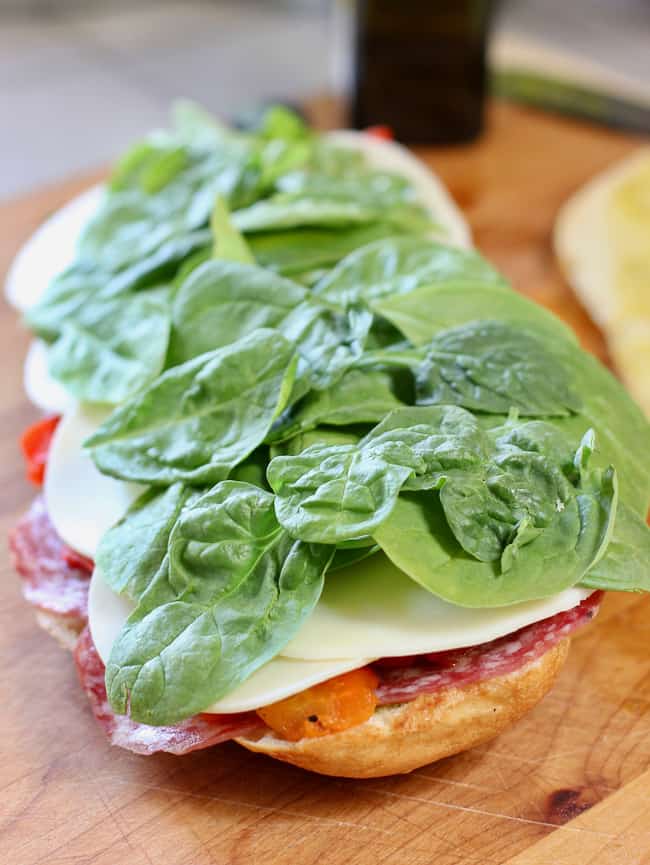 layer of spinach on italian sandwich