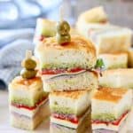 Pressed Italian Sandwiches stacked up on a platter