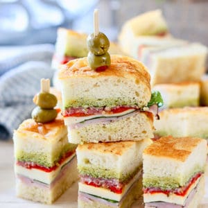 Pressed Italian Sandwiches stacked up on a platter