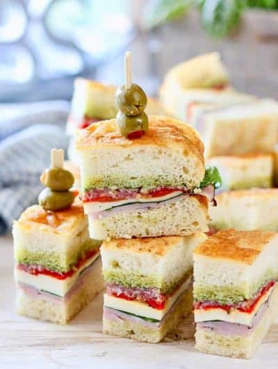 Pressed Italian Sandwiches stacked up on a platter