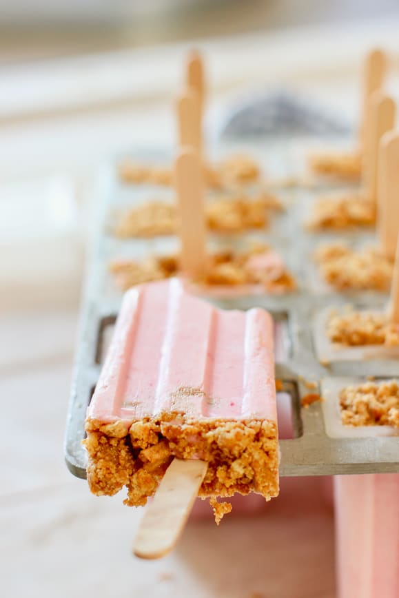 strawberry popsicles showing the graham crust