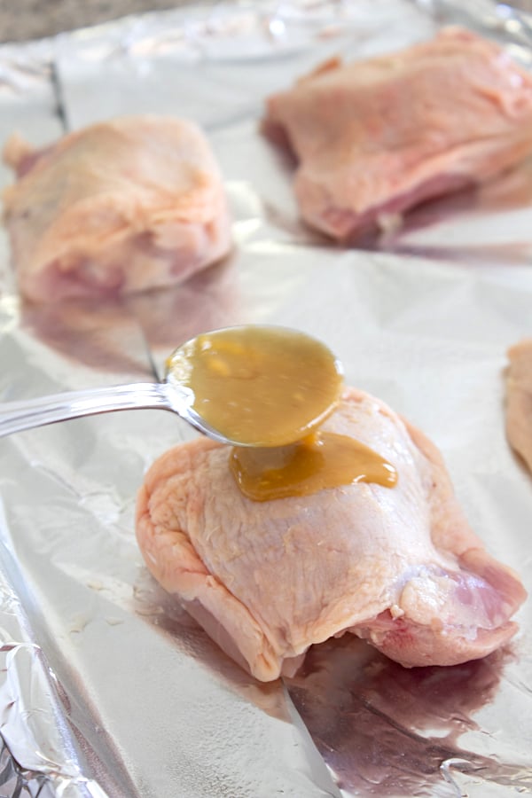 adding maple mixture to chicken thigh