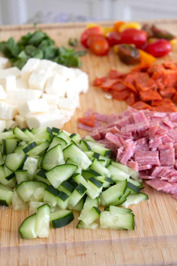 chopped salad ingredients on a cutting board