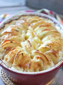 Cheesey Au Gratin Potatoes in a red casserole