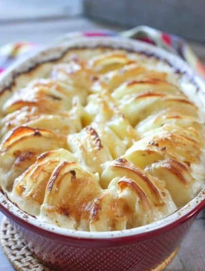 Cheesey Au Gratin Potatoes in a red casserole