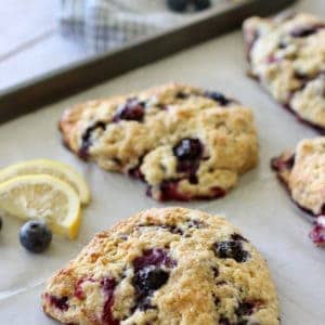 Lemon Blueberry Scones on a baking sheet with parchment