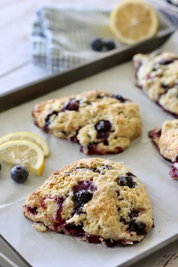 Lemon Blueberry Scones on a baking sheet with parchment