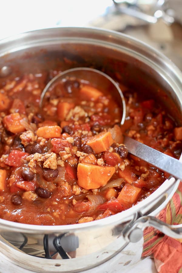 large pot of chili with a ladle