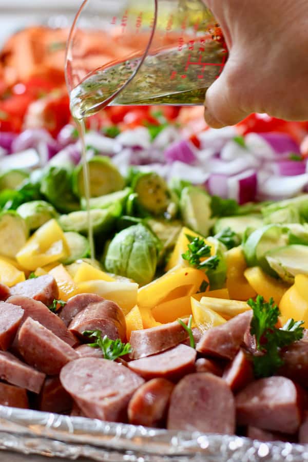 veggies being tossed in olive oil marinade