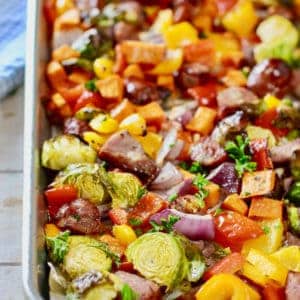baked sausage and veggies on a sheet pan