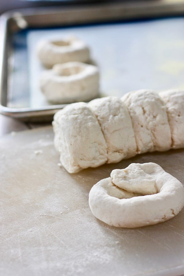 dough being rolled into bagel shape