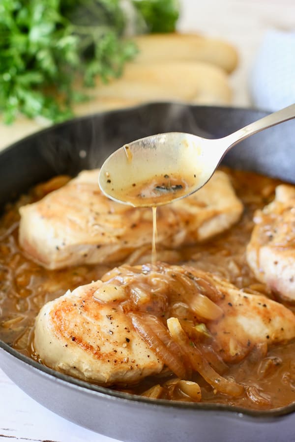 pan sauce being drizzled over chicken