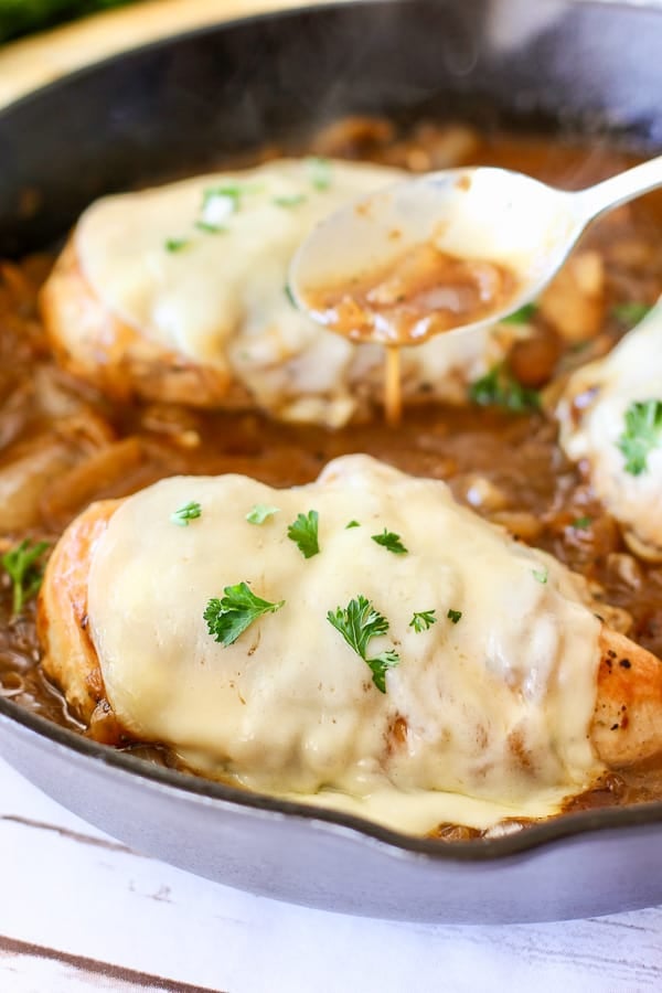 pan gravy being spooned over chicken