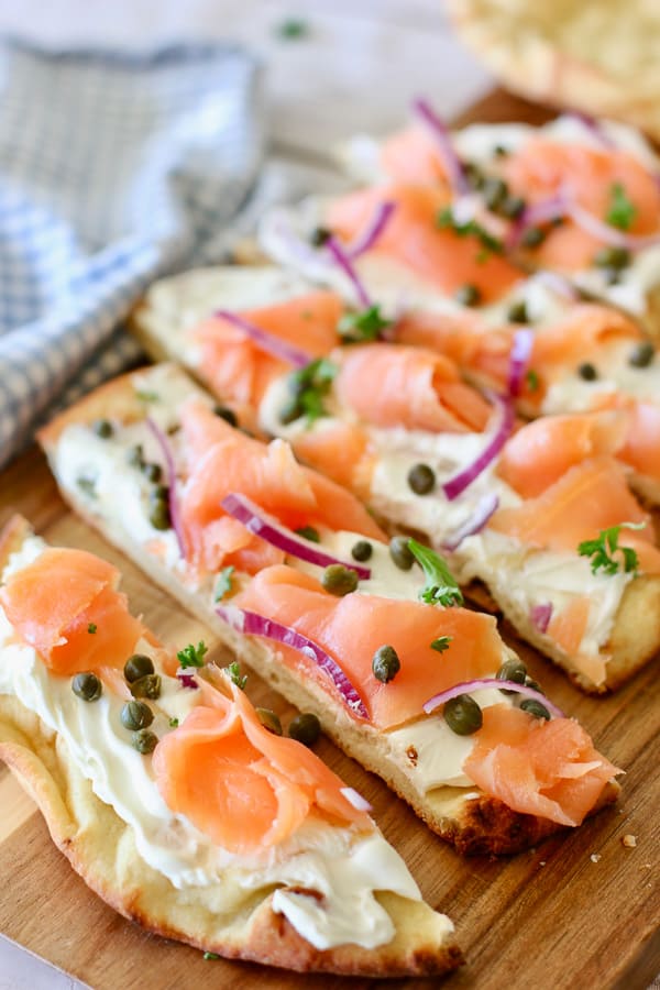 smoke salmon pizza sliced on board