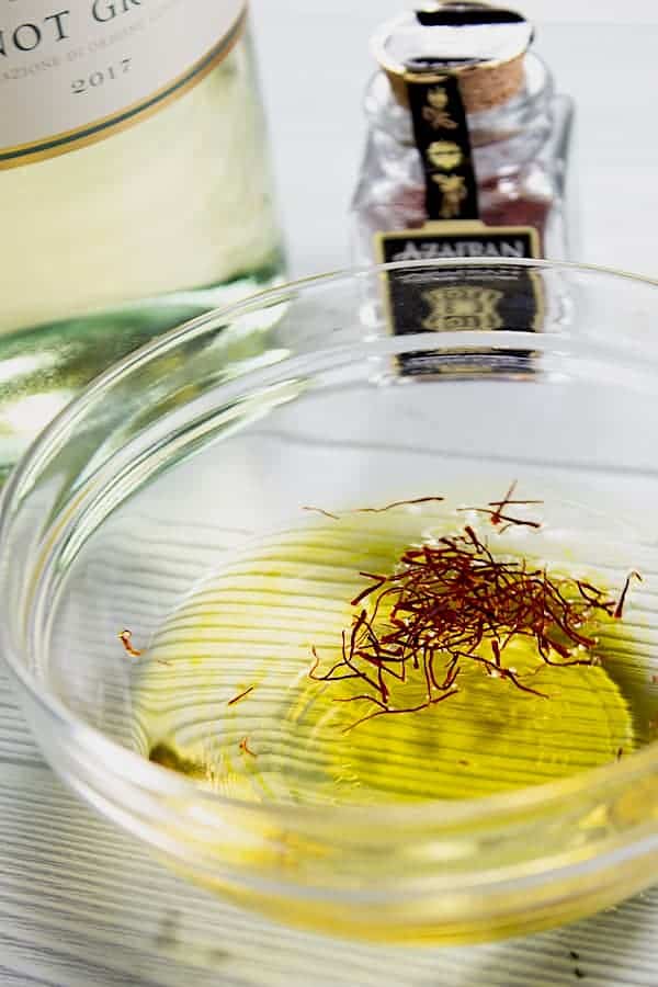 blooming saffron in clear dish of white wine