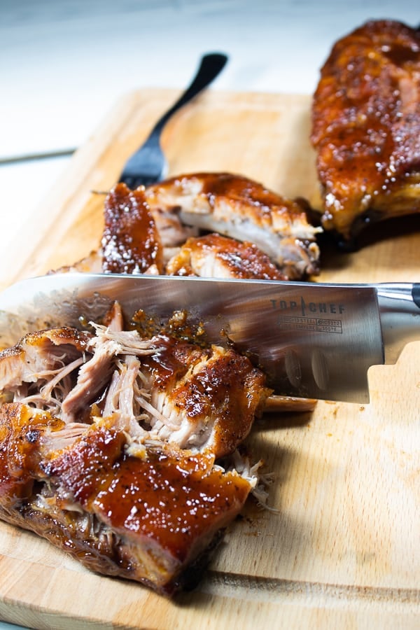 a bamboo cutting board slicing oven baked ribs