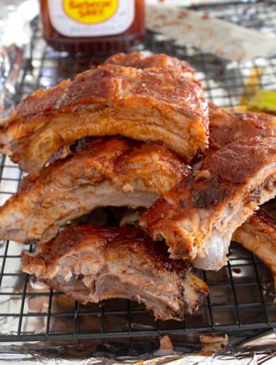 overhead view of ribs with bbq sauce in the background