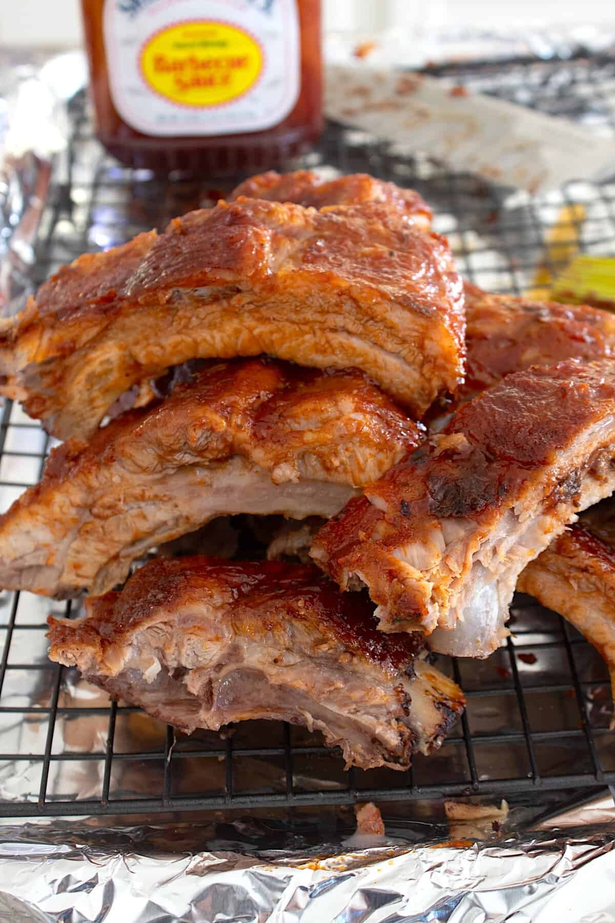 overhead view of ribs with bbq sauce in the background