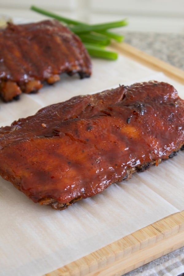 slab of ribs on parchment paper on cutting board