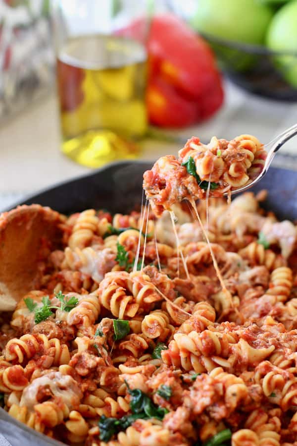 cheese italian pasta skillet being served in a cast iron pan