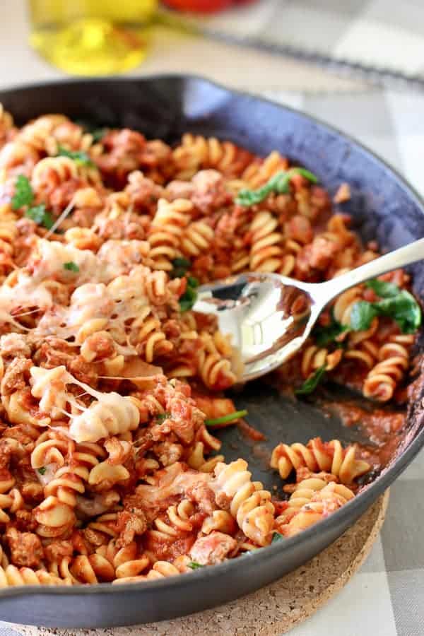 pasta in a cast iron pan being served