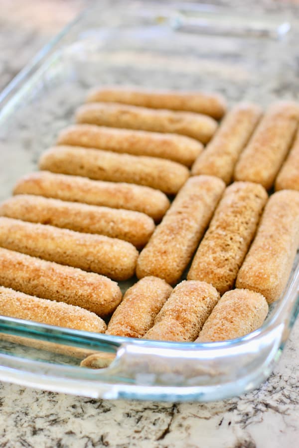 lady fingers soaked in coffee in a pan