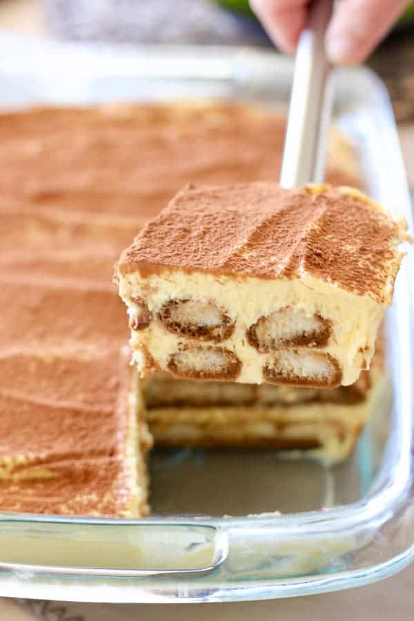 Tiramisu being served on a spatula