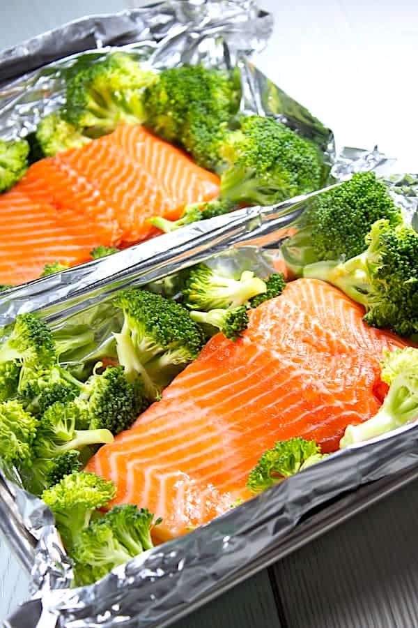 raw salmon and broccoli in foil pouch