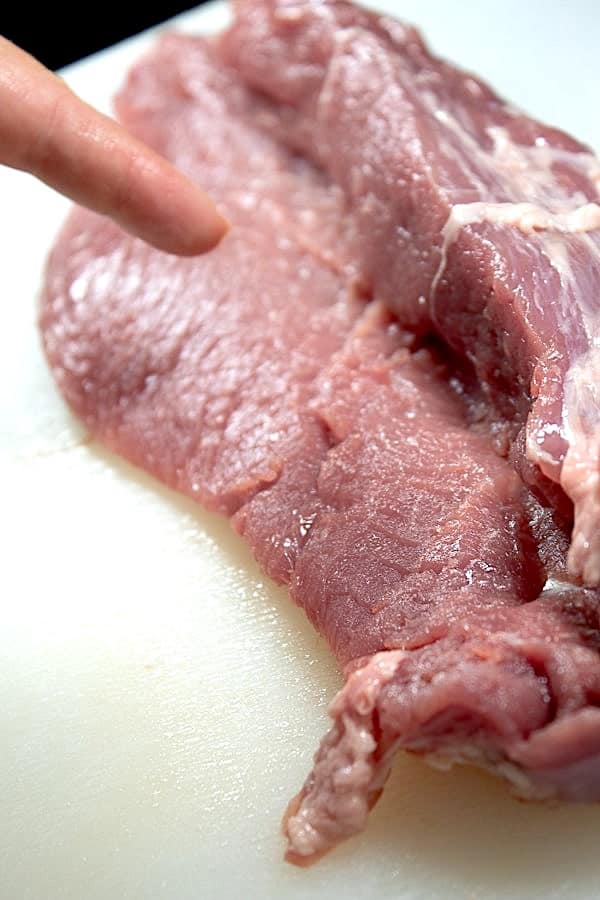 showing how to butterfly pork tenderloin by cutting like a book