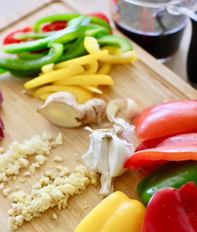 peppers garlic and ginger on a cutting board