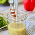 poppyseed dressing in a jar with a spoon