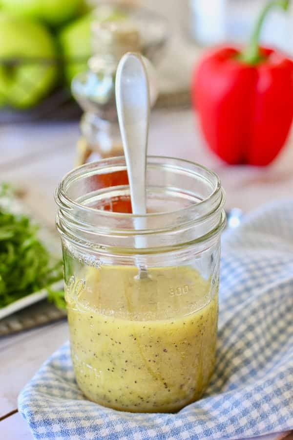 poppyseed dressing in a jar with a spoon