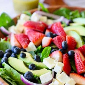 strawberry salad ingredients in a large wooden bowl