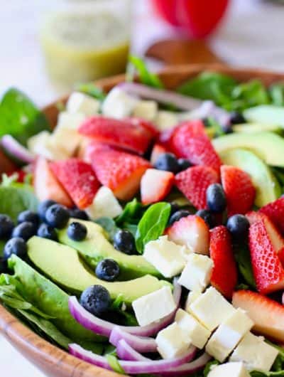 strawberry salad ingredients in a large wooden bowl