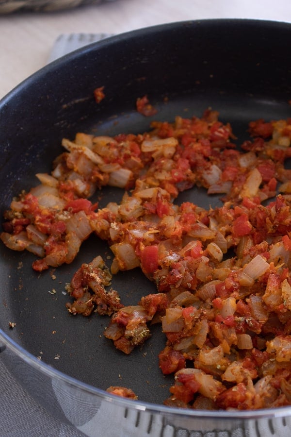 cooked Onion and Red Pepper in pan for cajun sauce 