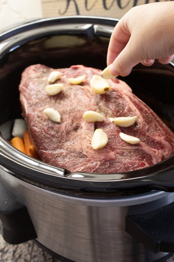 Slow cooker pot roast with garlic on top