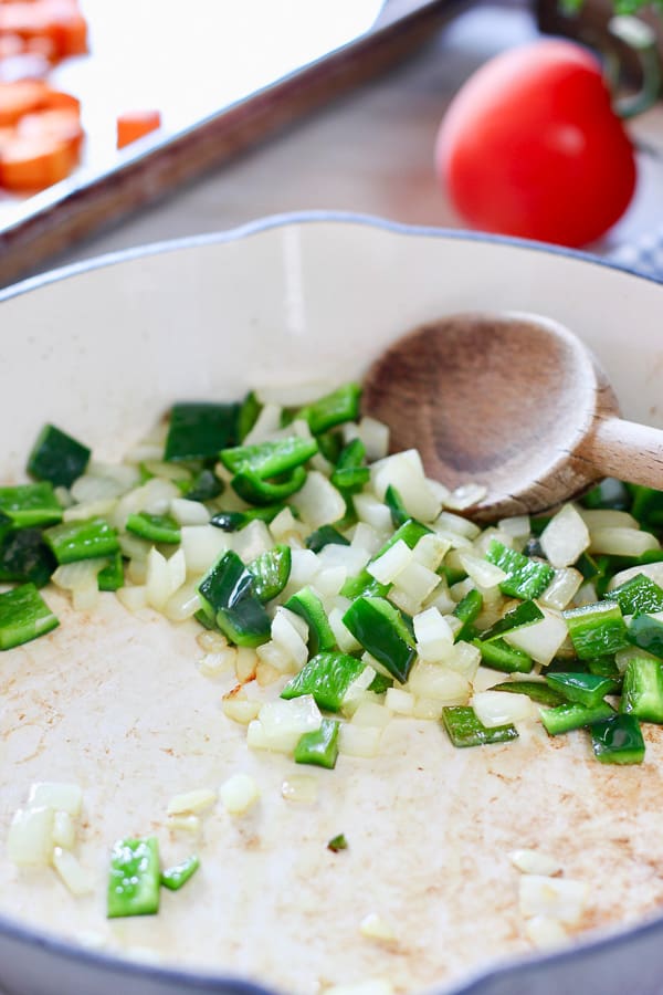 peppers and onion in a cast iron pan