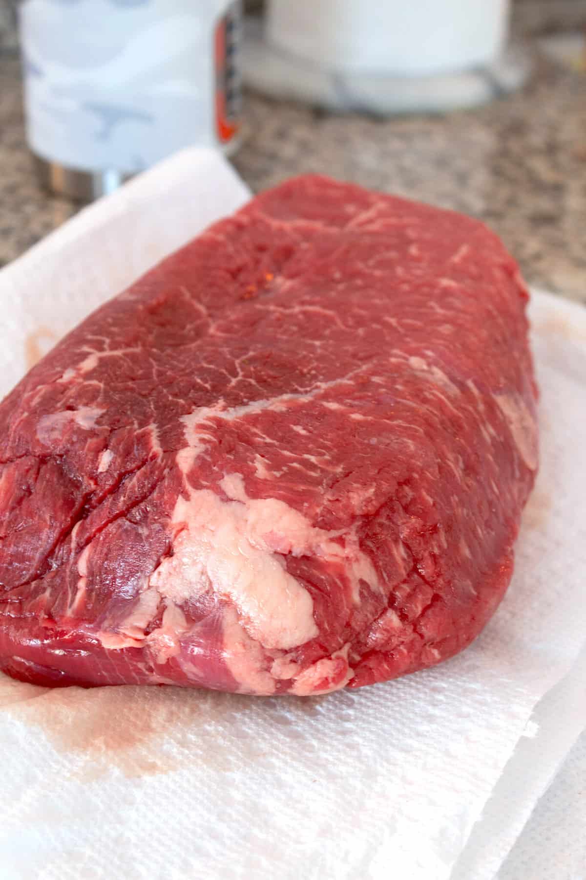 raw chuck roast on a paper towel