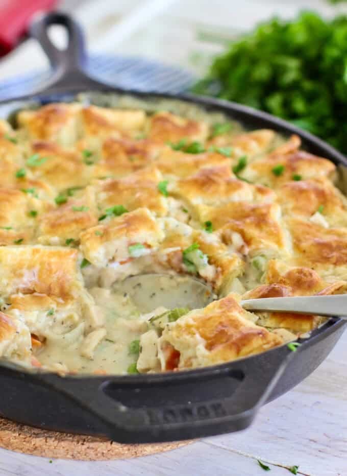 Chicken pot pie being served from a skillet