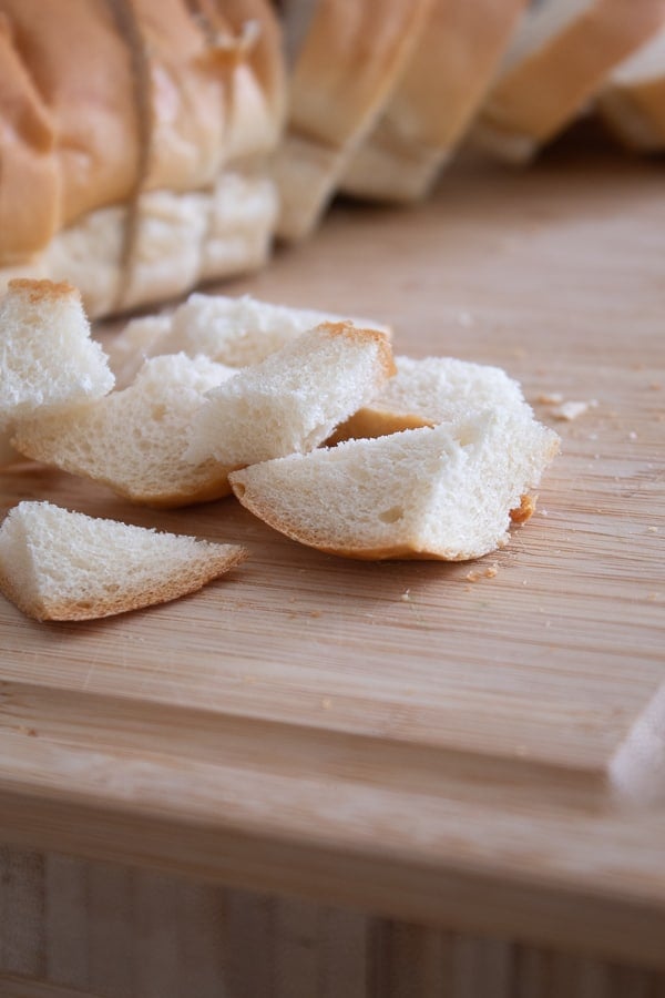 cubed French loaf on a cutting board