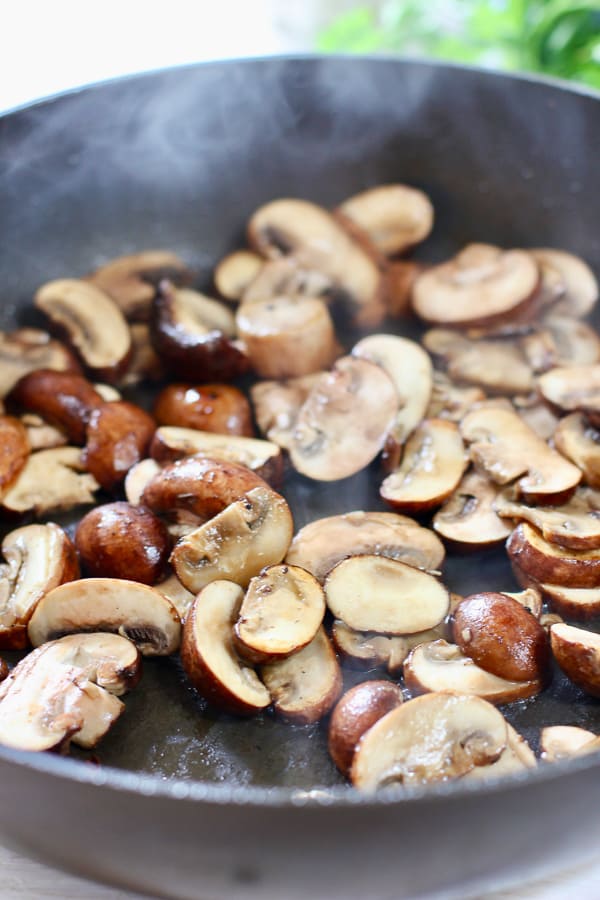 mushrooms cooking in skillet