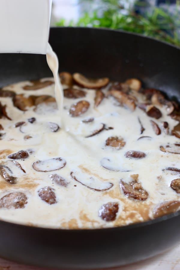 cream being poured into mushrooms